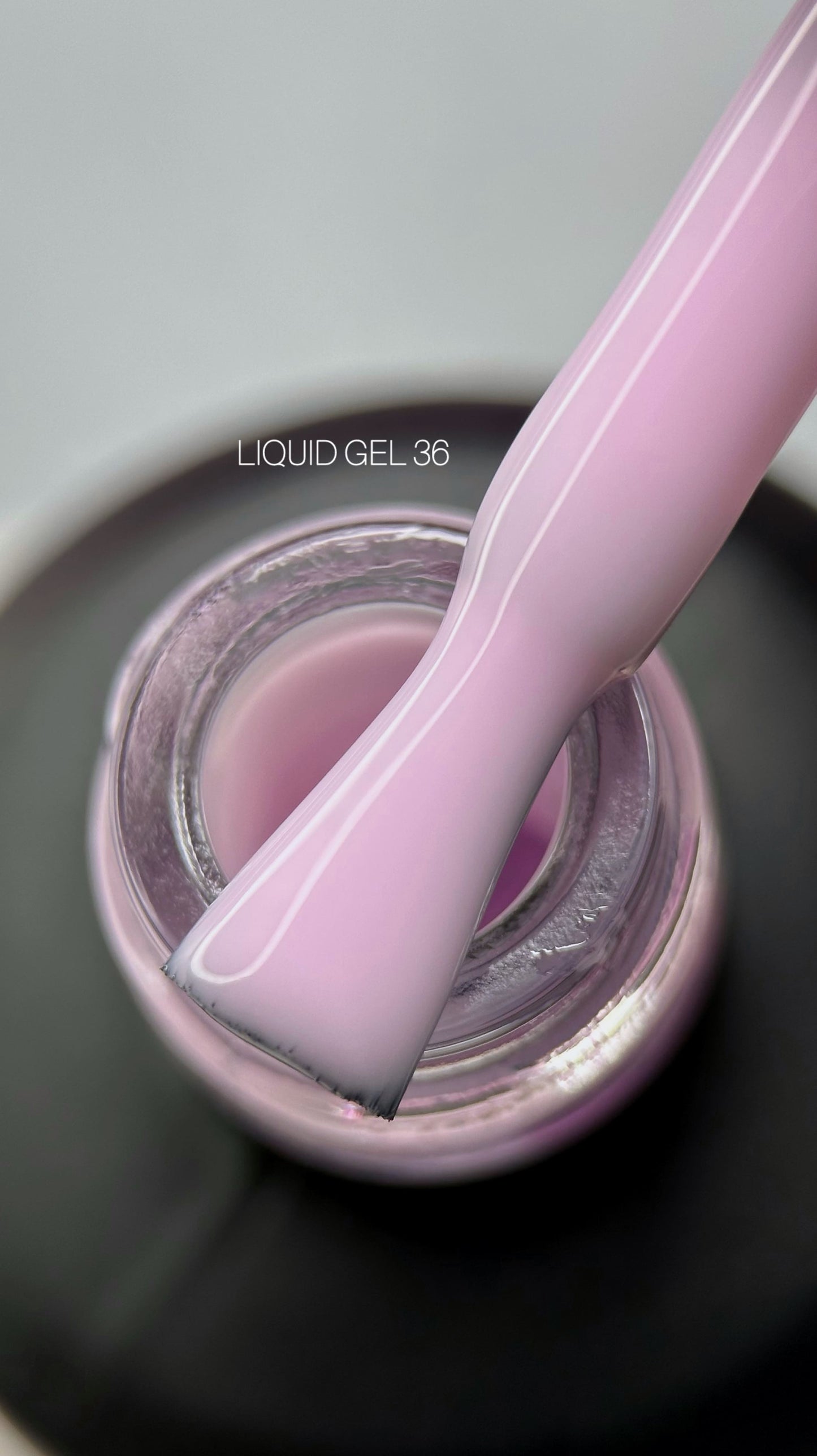 Liquid gel polish in a vibrant pink shade, showcasing a smooth and glossy finish. Ideal for manicured nails.