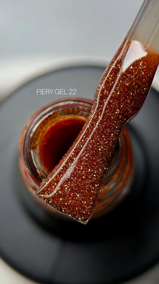 A close-up view of a bottle filled with Saga Fiery Gel #23 vibrant red glitter gel, showcasing its shimmering texture and rich color.