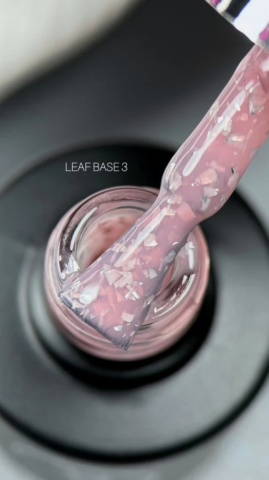 A hand applies pink nail polish using a brush, showcasing the vibrant color and precise application technique.
