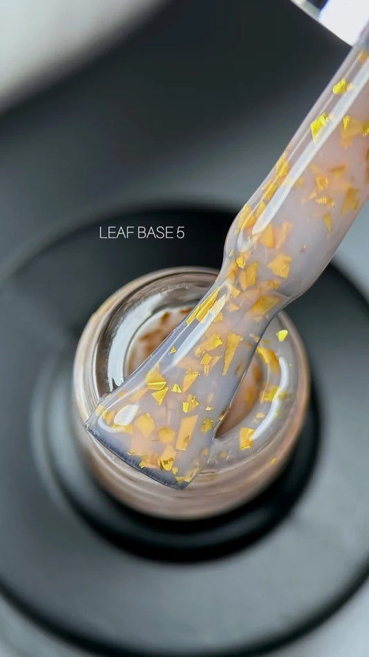 A hand applies pink nail polish using a brush, showcasing the vibrant color and precise application technique.