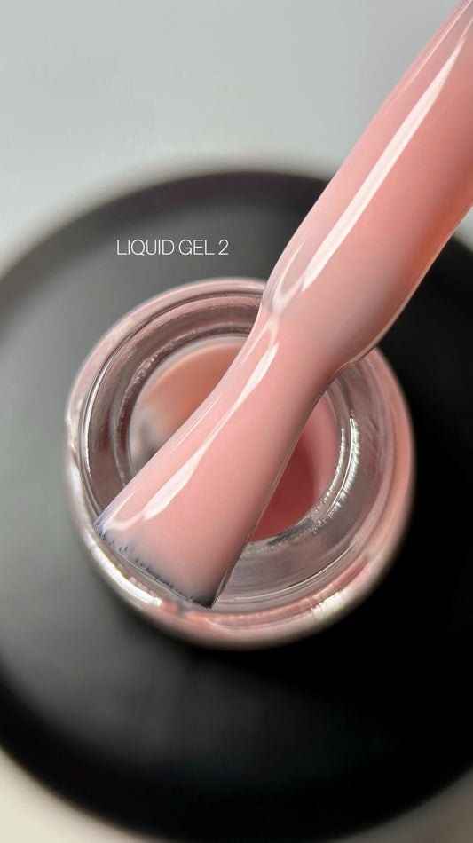 Liquid gel polish in a vibrant pink shade, showcasing a smooth and glossy finish. Ideal for manicured nails.